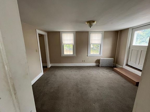 Walk in from deck into the living room through the door on the right. Picture taken from a room that could be a 3rd bedroom or an office