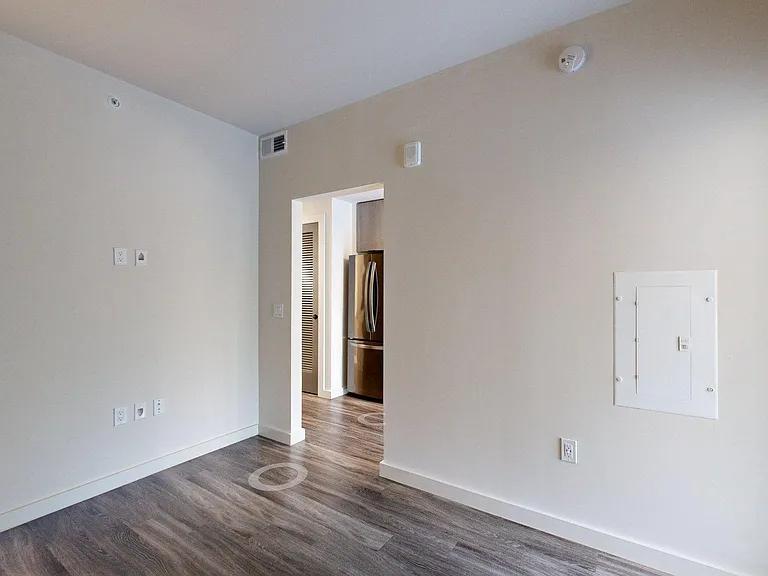 Spacious apartment Bedroom with wood flooring.