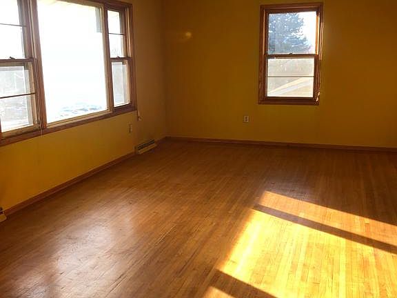 Light filled living room with hardwood floors.