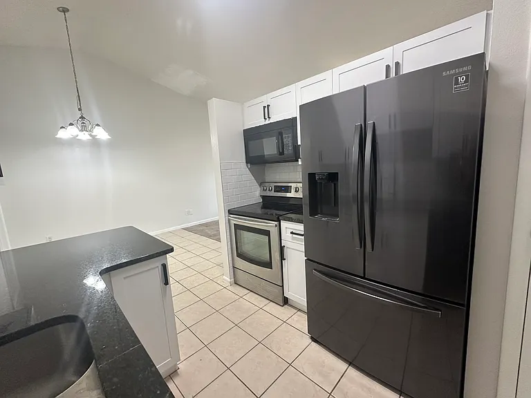 Kitchen with brand new cabinets, granite counter and sink/faucet.