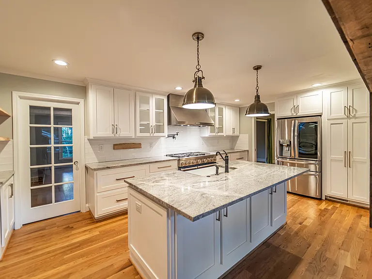 Handpicked high-end granite, custom fixtures, live-edge wood shelving, magnetic knife mount.