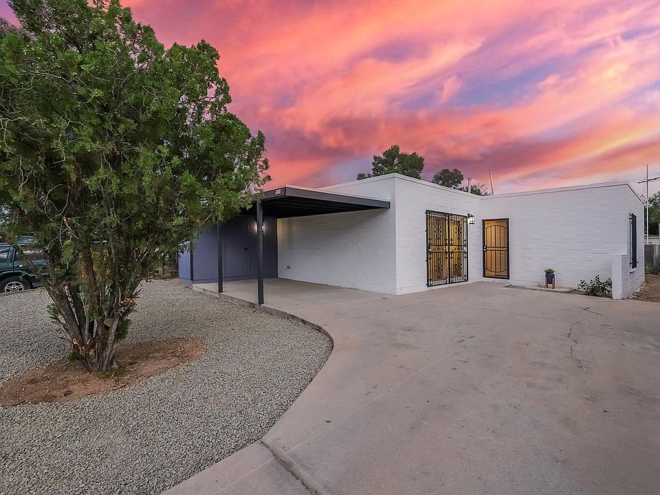 Front of house with trimmed tree and new decorative gravel.