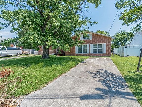 Driveway on the right side and gate access to the backyard. branch limbs will be removed. 