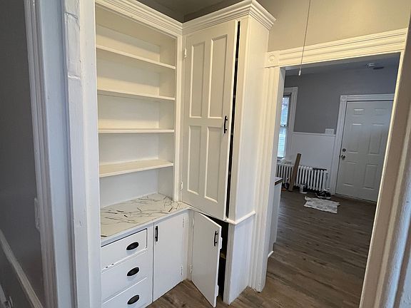 Butler Pantry between Kitchen and dining room. Plenty of cabinetry and shelving.
