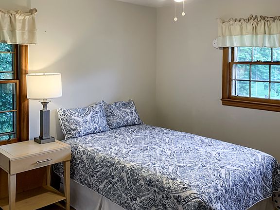 Comfortable bed, nightstand, lamp, seating, & ceiling fan for your comfort!