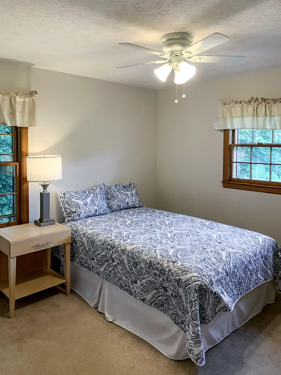 Comfortable bed, nightstand, lamp, seating, & ceiling fan for your comfort! - Beechwood Dr