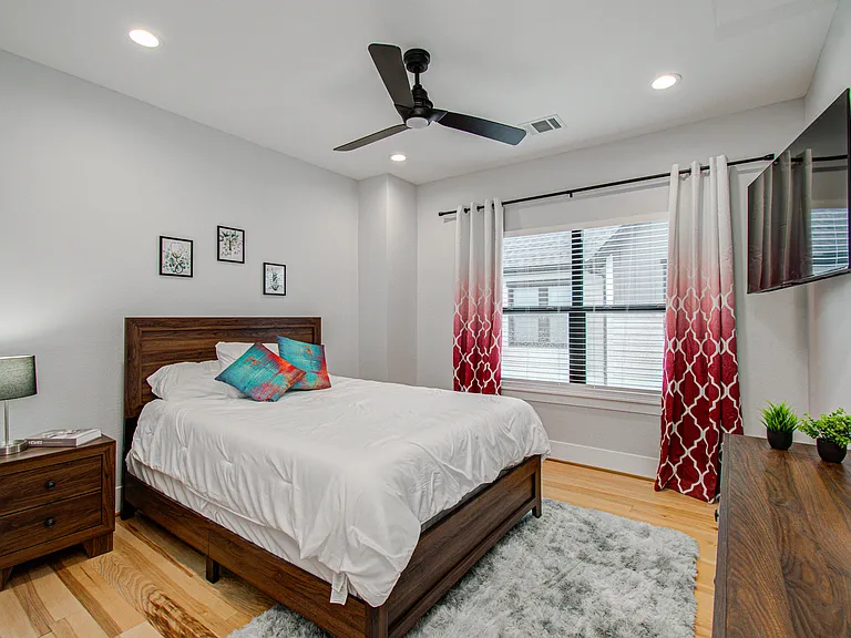 Comfortable second bedroom featuring a queen bed with a brand-new memory foam mattress and Smart TV, providing a relaxing and private retreat during your stay.