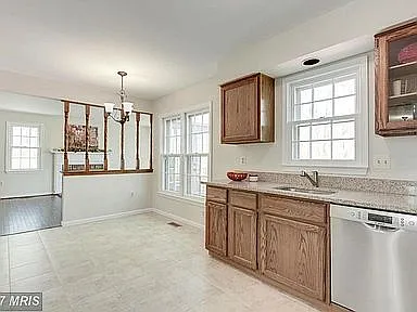 Kitchen facing back yard and second living room. Note: Wooden rails no longer separate kitchen from second living room.