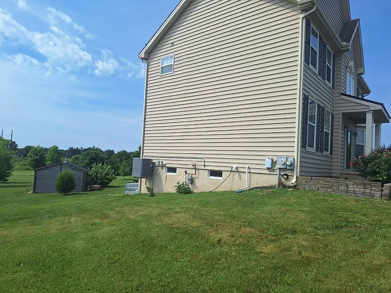 Enjoy a spacious yard with plenty of open green space, providing room to relax and enjoy the outdoors.