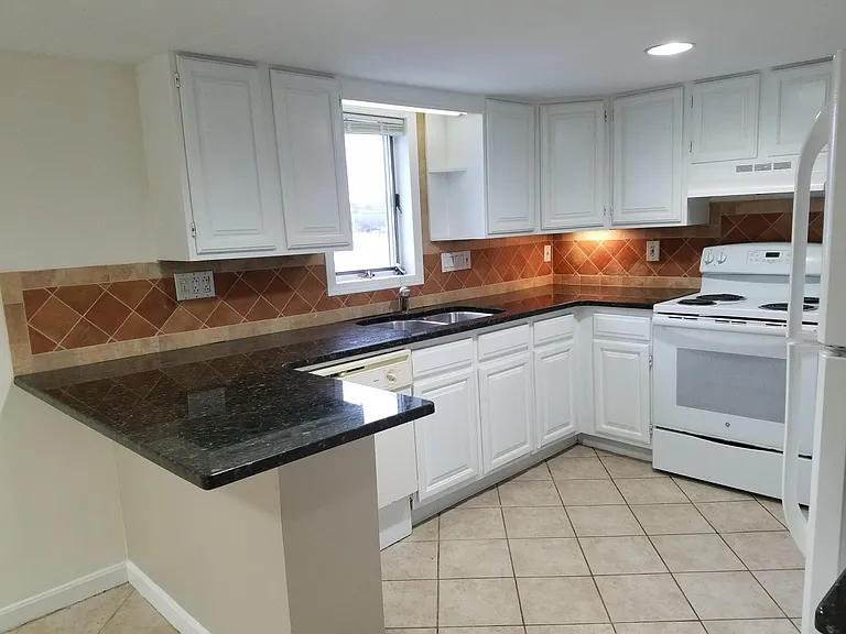 Kitchen with stove, dishwasher and refrigerator