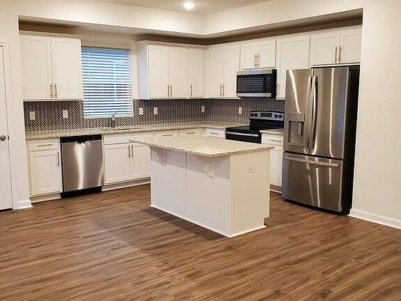 Kitchen with granite counters and tile backsplash