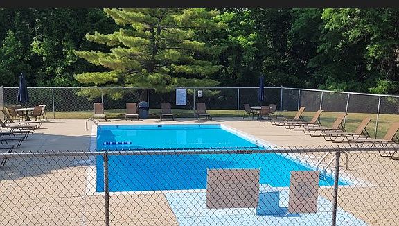 Swimming pool with tanning chairs.