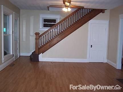 Living Room 1 : Laminate floors and beautiful original wood banister.