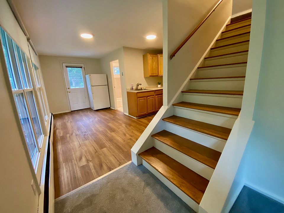 Kitchen table area in front of windows, door to exterior, refrigerator and doorway to the full bathroom which is on this level.