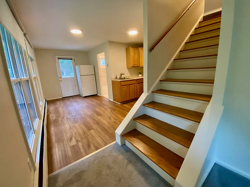 Kitchen table area in front of windows, door to exterior, refrigerator and doorway to the full bathroom which is on this level.