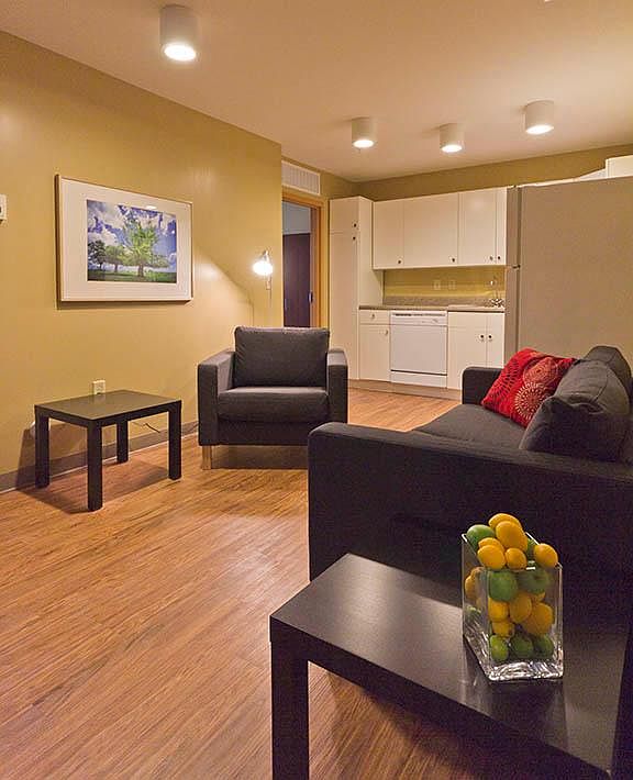 Living area complete TV, sofa, soft side chair, LED lighting plus thermostat for unit built in HVAC