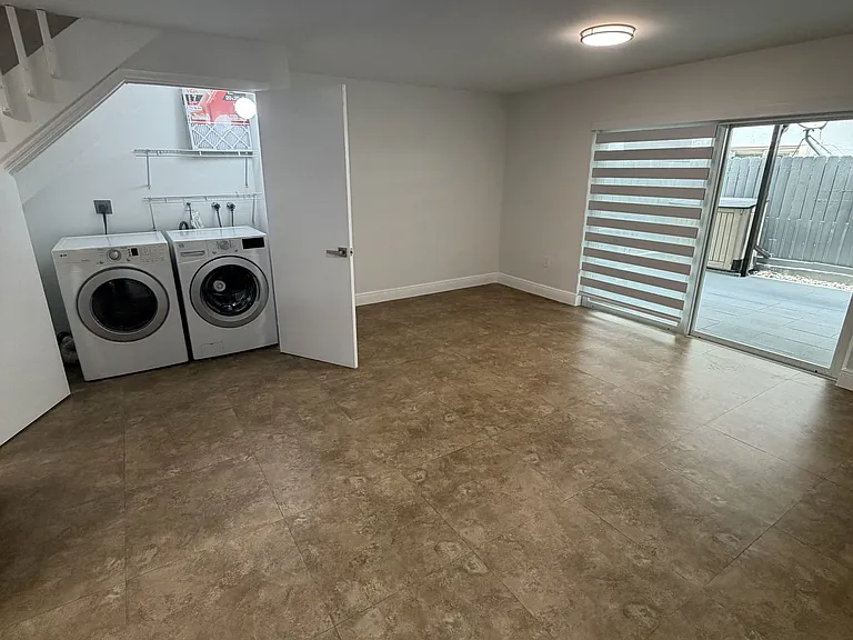 Living room with washer and dryer