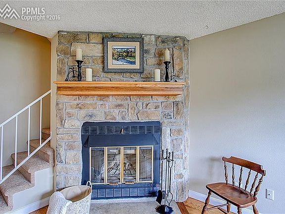 Stone fireplace in living room.