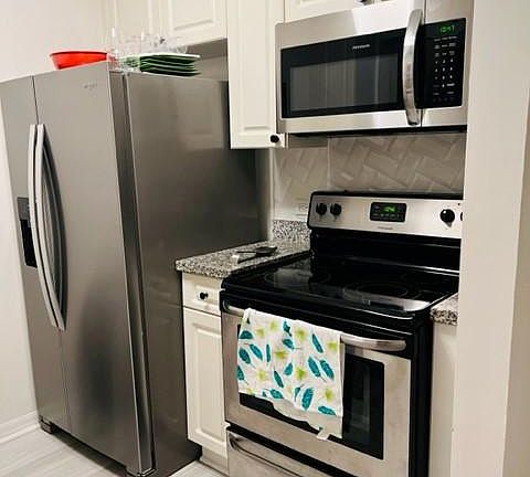 Kitchen with new flooring and appliances.