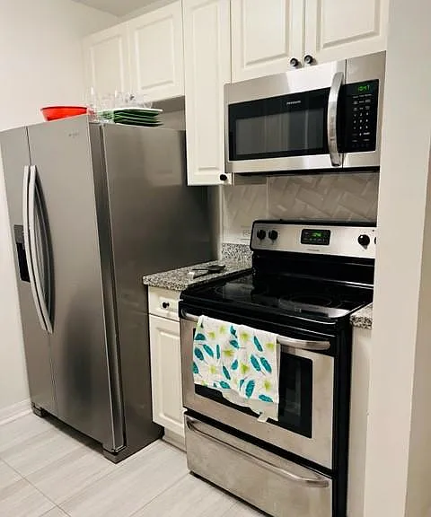 Kitchen with new flooring and appliances.