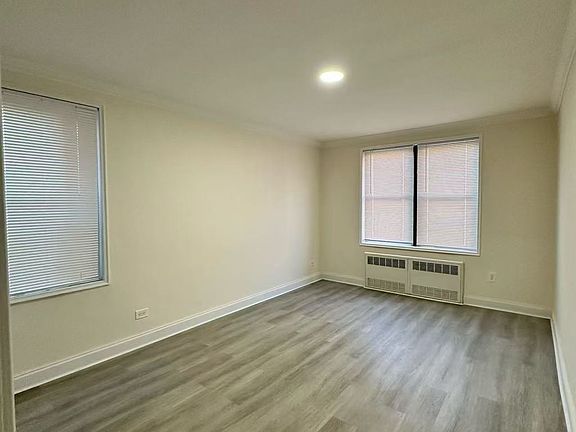 Main bedroom - 2 windows for natural cross ventilation, new, durable, maintenance free composite flooring. Fresh paint. New overhead LED lighting.