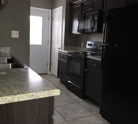 Kitchen with a view to the back door (enters into a privacy fenced in back yard)