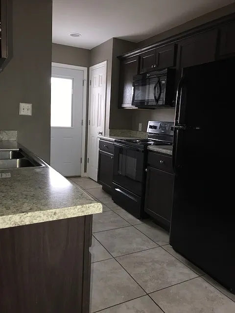 Kitchen with a view to the back door (enters into a privacy fenced in back yard)