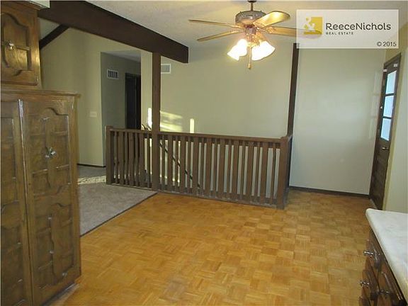 Kitchen and eating area. Door leads to deck. Stairs lead to finished lower level.