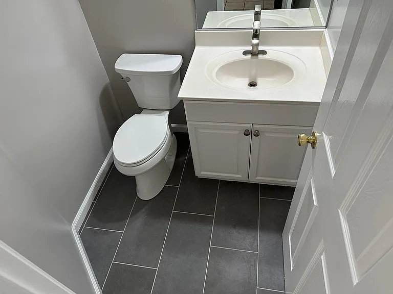 Rec Room / Office bathroom with new toilet, new faucet, and new flooring