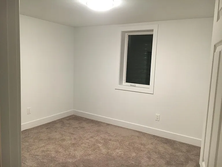 One of the basement bedrooms showing the egress window.
