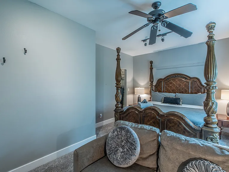 A spacious retreat featuring a grand bed and cozy seating.