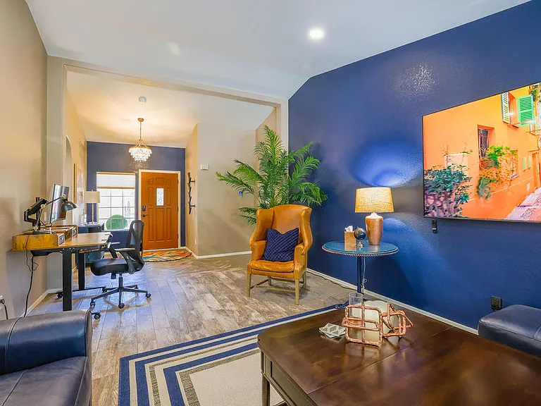 Open plan living room, dining room, kitchen, entry way.
Living room has 2 leather couches with queen size hide away bed, dining table seats 10, sliding door to patio seating