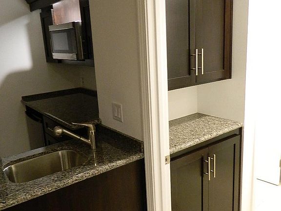 Partial Kitchen view and hallway storage or Linen closets to right on way to bathroom.