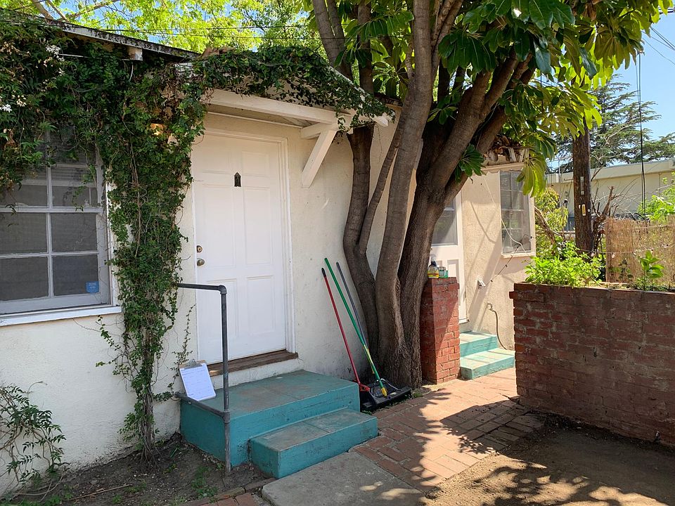 View of the front of the house-at end of the alleyway and behind the fence