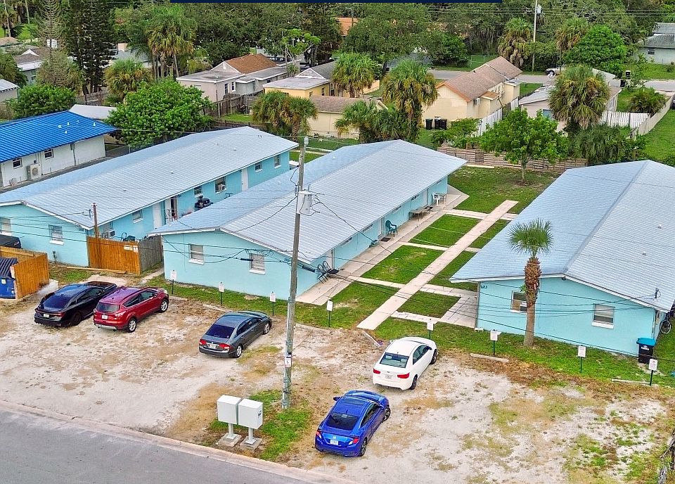Main Property. Notice the 2 car deep designated parking spaces and concrete walking paths in the common areas.