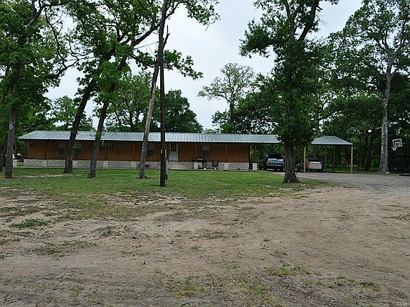 Close up of Home w/Beautiful Wood/Stone Front & Large Covered Patio.