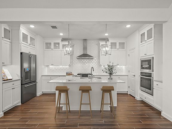 Kitchen with pendant lights vast island