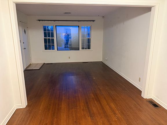 Open living room/dining room with pretty wood floors.