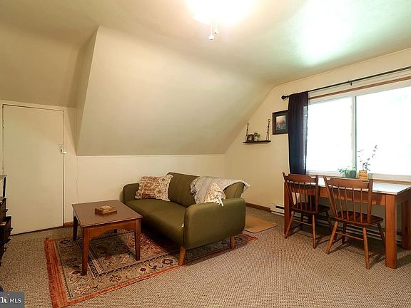 Bright and inviting living space featuring a large window that showcases stunning scenic views.