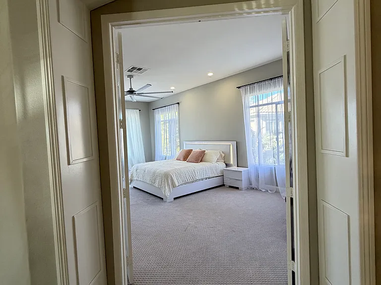 Elegant arched entryway opening to the private primary suite.