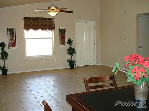 Dining area to living area and front door view.