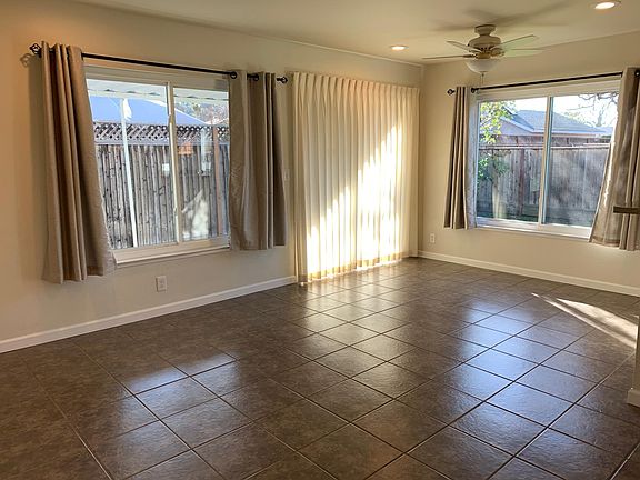 Dining area. Slider behind drapes leads to covered patio. Kitchen to the right.