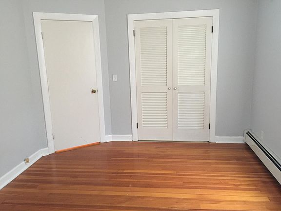 Bedroom with large closet, hardwood floor.
