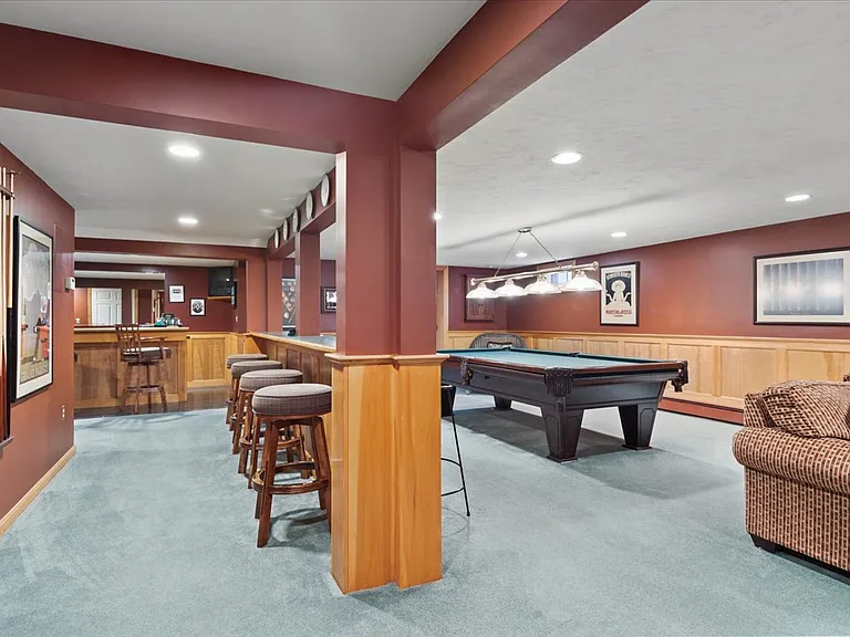 Basement rec room with counter/stools.