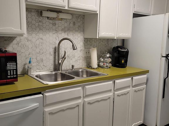 Kitchen has a dish washer, electric stove/oven, refrigerator, microwave, coffee maker and lots of cabinets