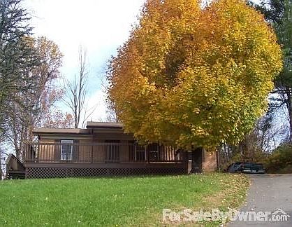 View from Hank St
						:
						House as seen from Hank Street- paved driveway--large maple for summer shade.
