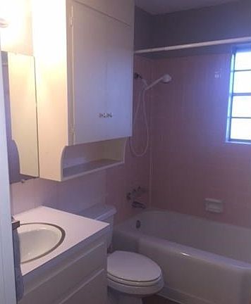 Hallway bathroom has tub/shower combo. Additional storage and countertop area.