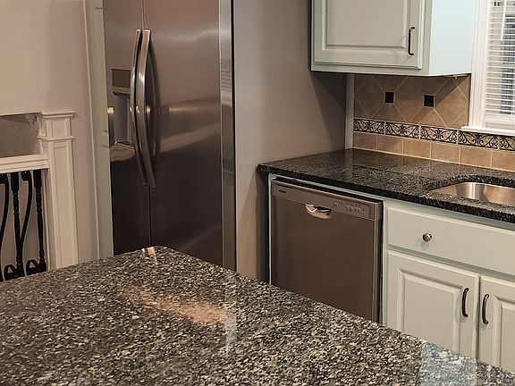 Kitchen with stainless steel appliances and granite countertops.
