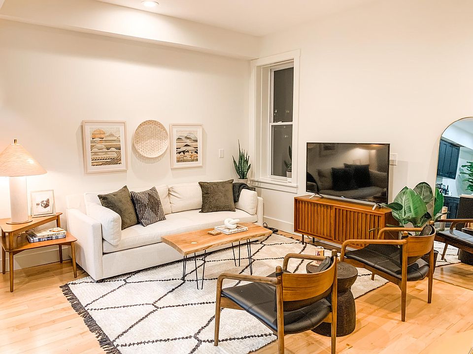 Open concept living room connects to the kitchen and dining room. 12 foot ceilings and tons of windows.