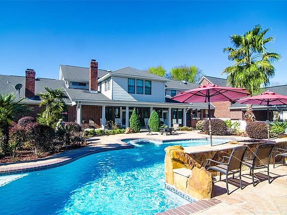 This custom home combines classical architecture with modern, expansive window space to create a bright and airy environment in harmony with its country setting.   The private, pool, with spa, waterfalls, compliments the house's unique design.  As you com